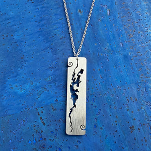 A stainless steel rectangular-shaped necklace pendant featuring a cut-out shape of Lake Champlain, with wave curl accents, by Close 2 UR Heart.